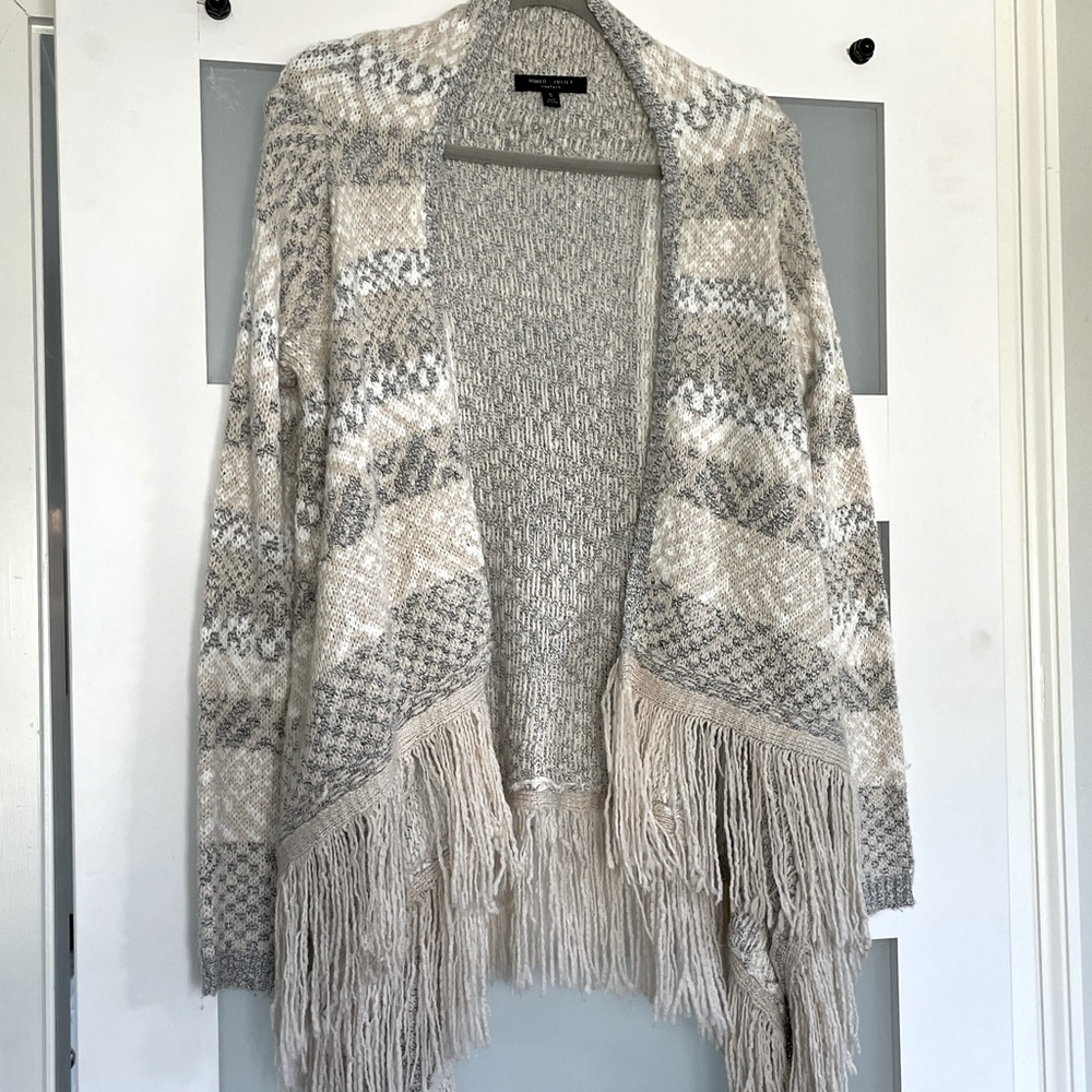 Neutral colored open knit cardigan with fringe hem
